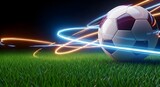 Soccer ball with neon lights on green grass