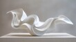 © mila103 - A white sculpture of a wave is on a table. The sculpture is made of white material and has a smooth, flowing shape. The wave appears to be in motion, as if it is about to crash onto the shore