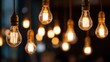 © mila103 - A bunch of light bulbs hanging from the ceiling. The bulbs are all different sizes and colors. The image conveys a warm and cozy atmosphere