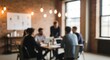 © sajibul35 - Blurred image of a diverse group of young professional people collaborating around a table in a modern, industrialstyle office meeting