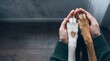 © Alena - Hands holding dog paws in animal shelter, showing compassion
