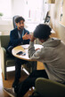 © Maskot - High angle view of male counselor giving advice to teenage boy facing problems in studies at high school