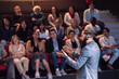 © Maskot - High angle view of male keynote speaker wearing headset explaining in seminar in theater