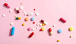 © Jaenal Jalalludin - Flat lay of various colored pills and capsules on a pink background. Health, supplements, medicine