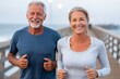 © Lubos Chlubny - Senior couple jogging on pier for fitness lifestyle