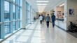 © delphine - Blurred bright hospital hallway with medical staff and patients moving through
