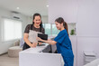 © Verin - attractive professional cosmetologist discuss with nurse assistant that holding tablet computer consulting beauty treatment at aesthetic clinic