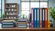 © Mahamud - Colorful binders and stacks of books on a wooden desk in an office