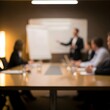 © TANZIM22 - Blurred image of a business meeting with a presenter at a whiteboard in a conference room