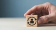 © Shabul - Hand holding wooden block with rotating person icon symbolizing employee turnover talent management or career change concept