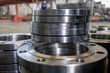 © Washburn - Stacked metal flanges in industrial workshop