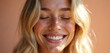 © Vadym - Young woman with freckles smiles with closed eyes. She has blonde wavy hair and a happy natural look. Her skin glows in soft sunlight, conveying pure joy and health.