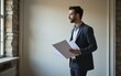 © Helen - Thoughtful man with papers standing on floor. High quality