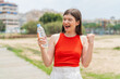 © luismolinero - Young pretty Ukrainian woman with a bottle of water at outdoors celebrating a victory