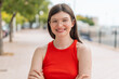 © luismolinero - Young woman with glasses at outdoors keeping the arms crossed in frontal position