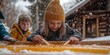 © bborriss - Children making maple taffy on snow in winter cabin