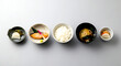 © Visions of Diversity - Minimalist flat lay, Japanese minimalist. a traditional breakfast set a small grilled salmon, a bowl of miso soup, a portion of rice, and pickled vegetables