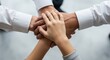 © Alice Y - Diverse hands unite in a gesture of teamwork and inclusion.