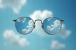 © Pete - Eyeglasses with clear lenses reflecting blue sky and white clouds. Glasses float in air against cloudy sky background. Clear vision and eye care concept. Modern eyewear and optical accessories.