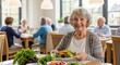 © Alice M - A smiling elderly woman enjoys a healthy meal with fresh vegetables in a bright dining room. Other seniors socialize in the background. Ideal for retirement and senior lifestyle content.