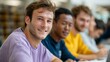 © Z A C - A group of young men sitting at a table in a classroom setting, smiling and looking towards the camera.