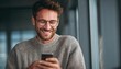 © Tetiana - Joyful Male Business Owner Checking Positive Text Messages While Chatting On Phone App, Delighted Employee In Glasses Laughing At Humorous Content.
