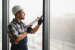 © Serhii - Construction worker applying sealant to window frame