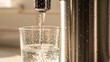 © Eric - Close Up Photo of a Modern Kitchen Water Filter Dispensing Clear Purified Water Into a Glass, With Droplets Sparkling Under Bright Lighting