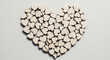 © Md. Tanjim Tanvir - A large heart shape composed of many small, lightcolored wooden heart cutouts arranged together on a plain background