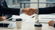 © BackgroundStudio - Soft focus handshake at a business meeting signifies agreement