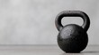 © Katsiaryna - Kettlebell with water droplets resting on a smooth surface in a gym setting