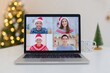 © World of AI - Diverse remote team on a video call displayed on a laptop screen, featuring individuals in festive sweaters and Santa hats, celebrating together during the holiday season