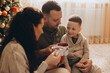 © dsheremeta - Family enjoying warm drinks during christmas holidays