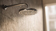 © Kanomaoi - Clear Water Streams Down from a Modern Chrome Shower Head in a Bathroom