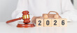 © Jo Panuwat D - 2025 end year to Happy New Year 2026 with small toy car models and Judges gavel on desk in courthouse. Car Law, Insurance, auto Tax, Auction and Bidding concepts