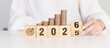 © Jo Panuwat D - 2025 end year to Happy New Year 2026 with Coins stack and dartboard icon. Strategy, goal, Money, Budget, tax, investment, financial, savings and New Year Resolution concepts