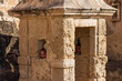 © Malik - Two smiling sisters framed by a watch tower window in an ancient castle construction during a sunny spring day.