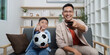 © itchaznong - Family Life: Father and son enjoying soccer and TV time together