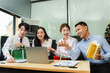 © NINENII - Asian people, celebrating together and gift exchange at Merry Christmas & Happy New Year. excited businessman feel happy work complete and celebration successful deal.