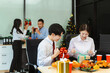 © NINENII - Asian people, celebrating together and gift exchange at Merry Christmas & Happy New Year. excited businessman feel happy work complete and celebration successful deal.