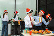 © NINENII - Asian people, celebrating together and gift exchange at Merry Christmas & Happy New Year. excited businessman feel happy work complete and celebration successful deal.