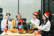 © NINENII - Asian people, celebrating together and gift exchange at Merry Christmas & Happy New Year. excited businessman feel happy work complete and celebration successful deal.