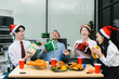 © NINENII - Asian people, celebrating together and gift exchange at Merry Christmas & Happy New Year. excited businessman feel happy work complete and celebration successful deal.