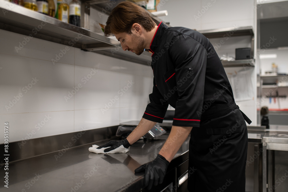 Chef cleaning kitchen counter after cooking in restaurant Stock Photo ...