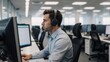 © Pixel Matrix - Business communication concept man at contact center working on computer in customer service and technical support role while wearing a headset