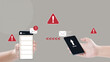 © Leo Lintang - Human hand holding a cellphone with warning signs and email icons indicating potential danger. Scam email or phishing attempt targeted at mobile devices. Concept of scam or phishing