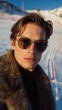 © OleksandrZastrozhnov - Young caucasian male in fur coat and sunglasses at snowy mountain resort