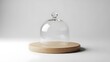 © Husein - Clear glass cloche on wooden base against white backdrop