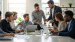 © SoysobSarkar - Team of Business Professionals Discusses Charts and Graphs During Meeting around Table in Office Diverse Group Collaborating on Project Reviewing Business Data