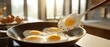 © Studio Nova - The sunny side up eggs sizzling in a skillet as a spatula lifts one